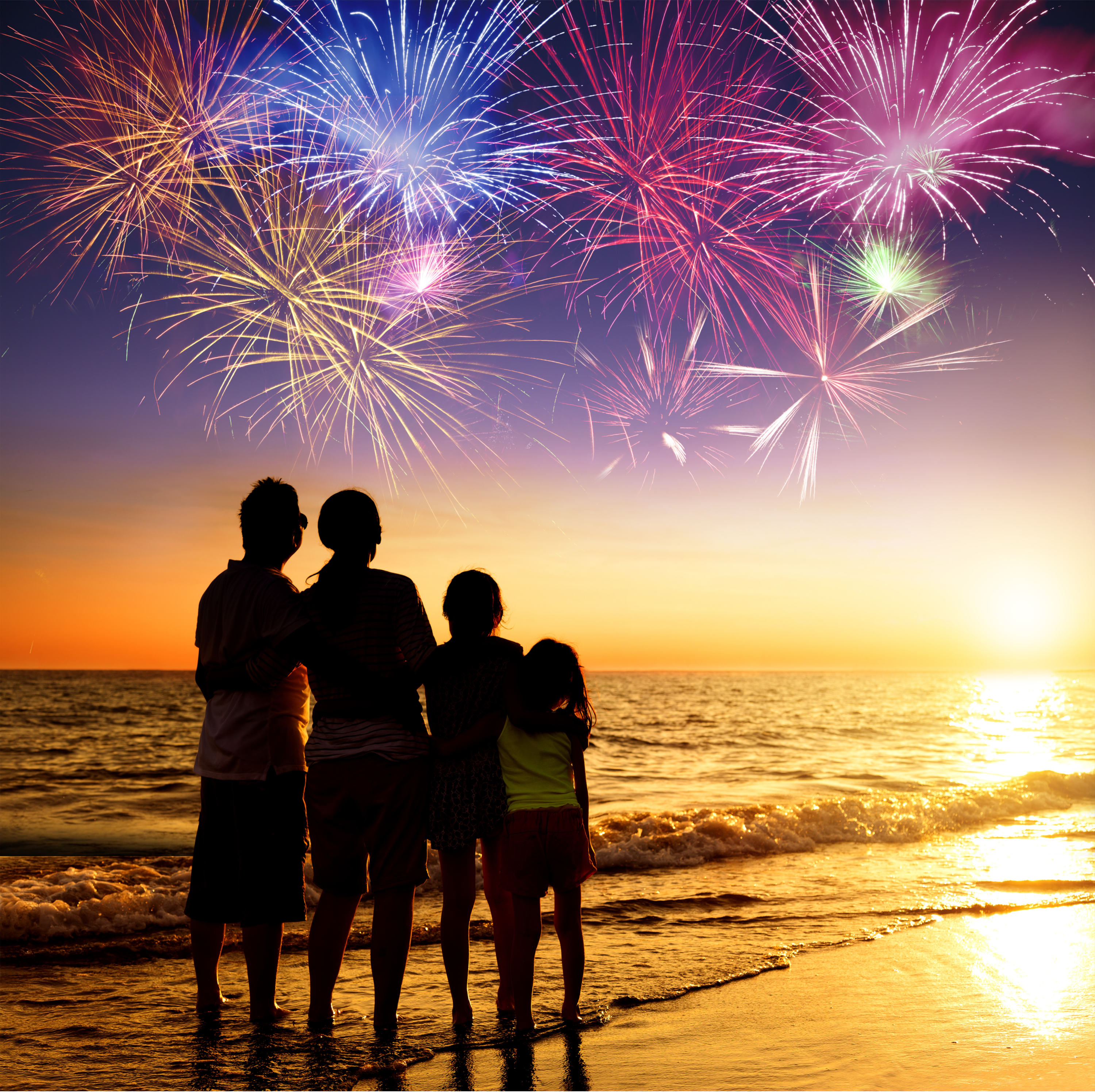 A family watching a fireworks show at the beach.summer | things to do in summer | things parents should do with their kids every summer 