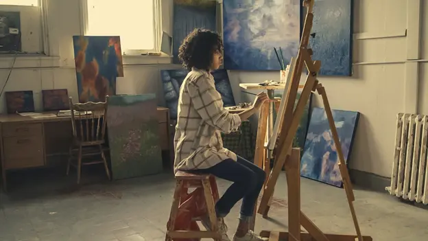 A woman painting on an easel - Scrap 'N Easel